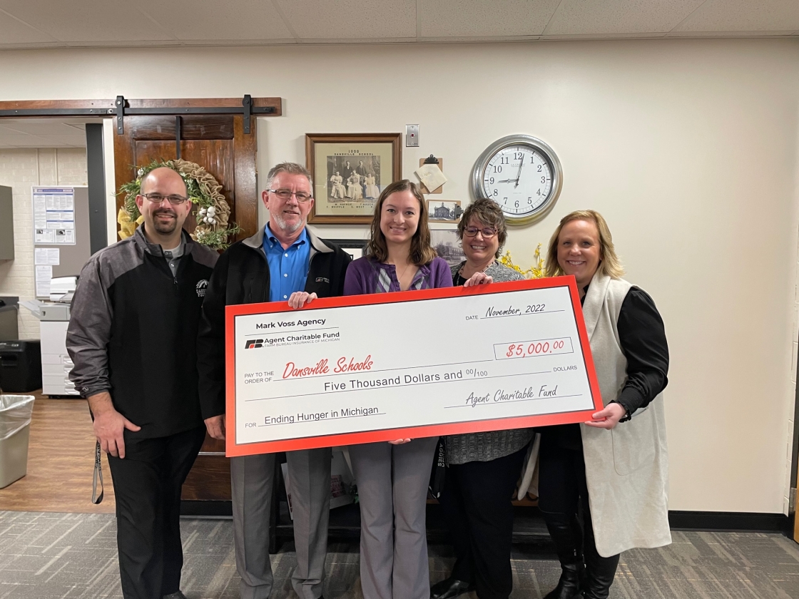 Mark presenting check to Dansville Schools